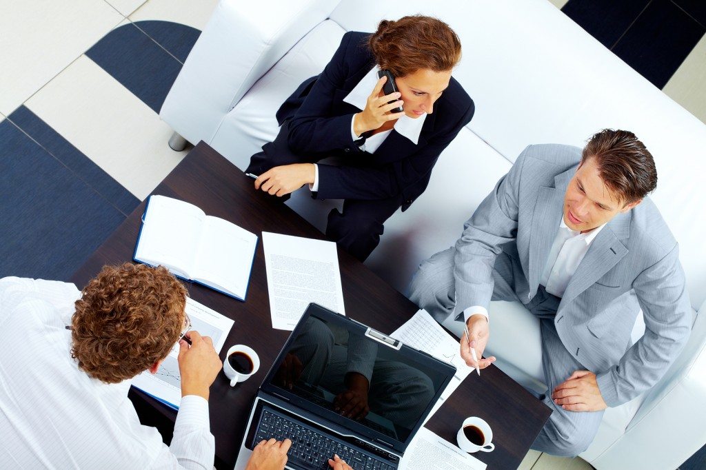 Image of company of successful partners discussing business plan