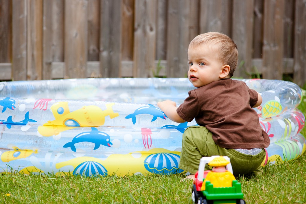 Child Playing By The Kiddie Pool